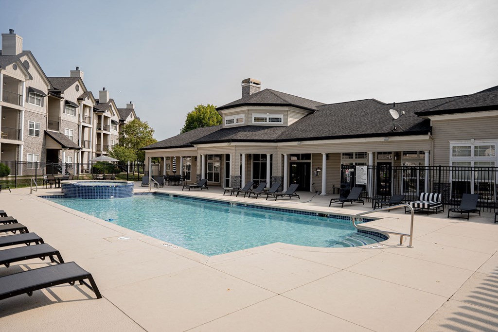 A large swimming pool surrounded by lounge chairs and buildings.at 92West, West Des Moines, 50266  