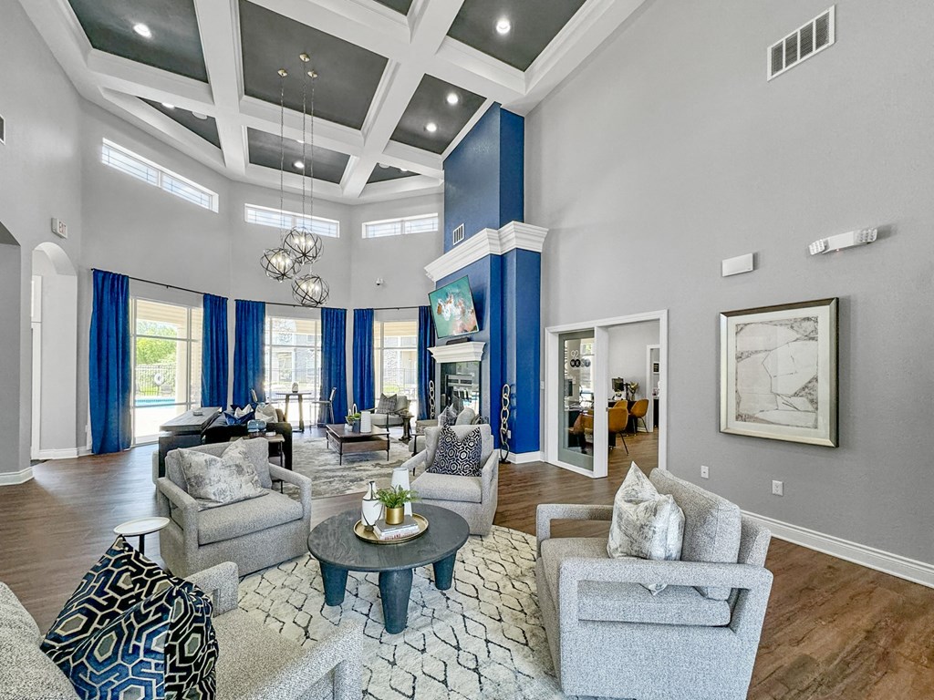 a living room with blue curtains and a white coffered ceiling at 92West, West Des Moines Iowa