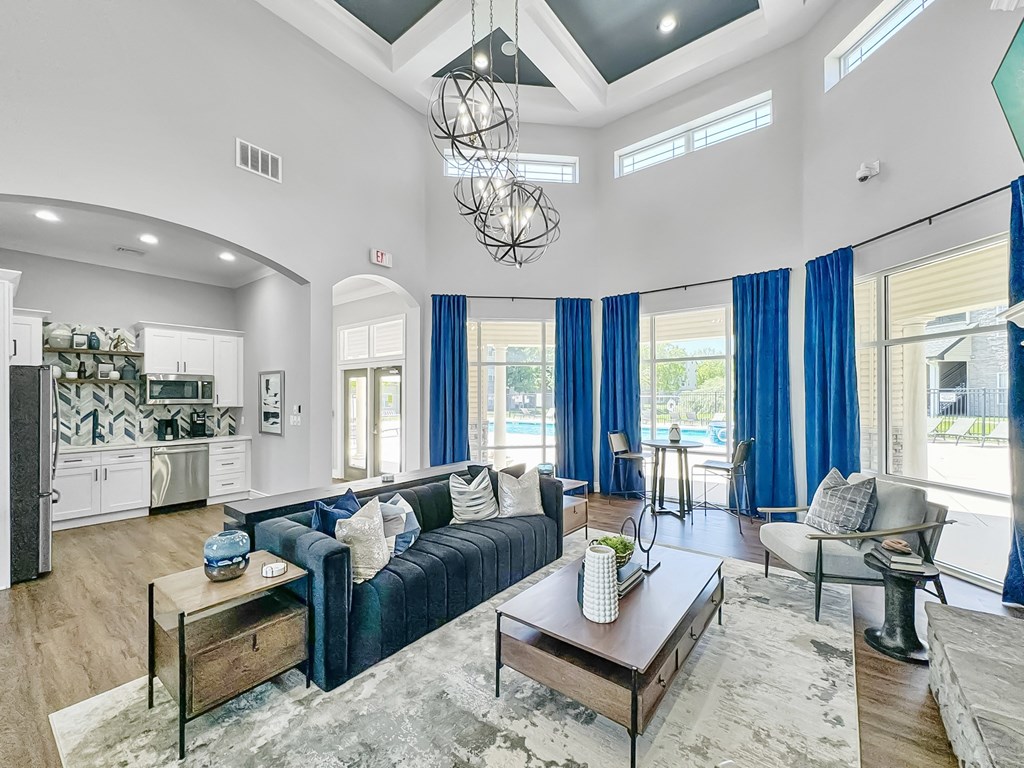 a living room with a blue couch and a coffee table at 92West, West Des Moines  