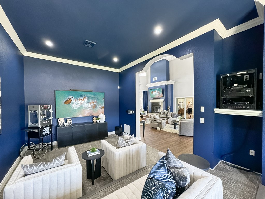 a living room with blue walls and white furniture at 92West, Iowa