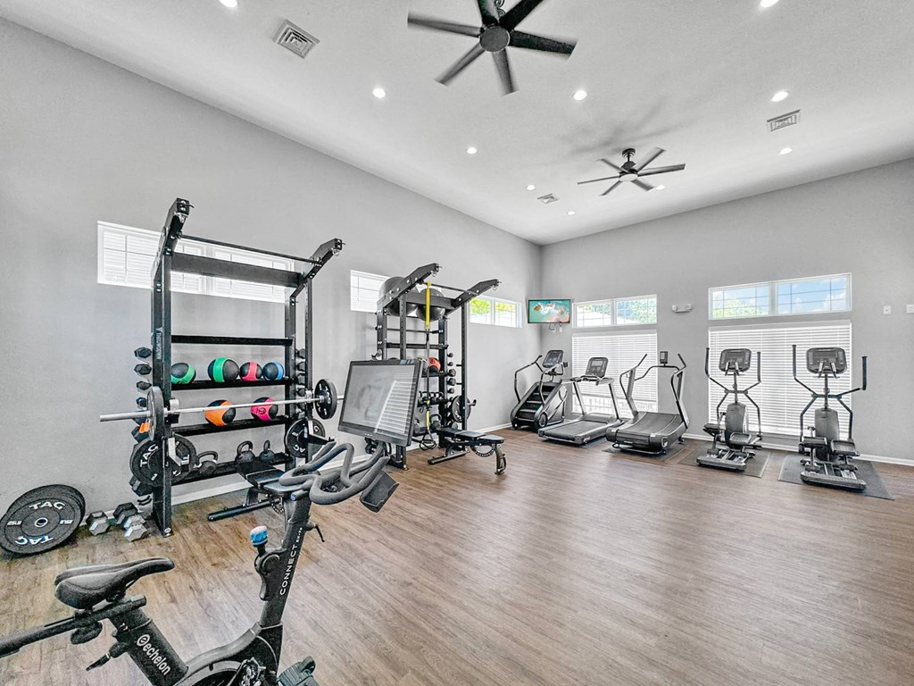 a home gym with exercise machines and a ceiling fan at 92West, Iowa  