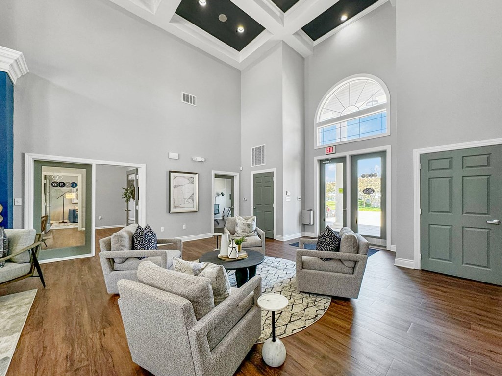 a living room with couches and a table at 92West, West Des Moines, IA  