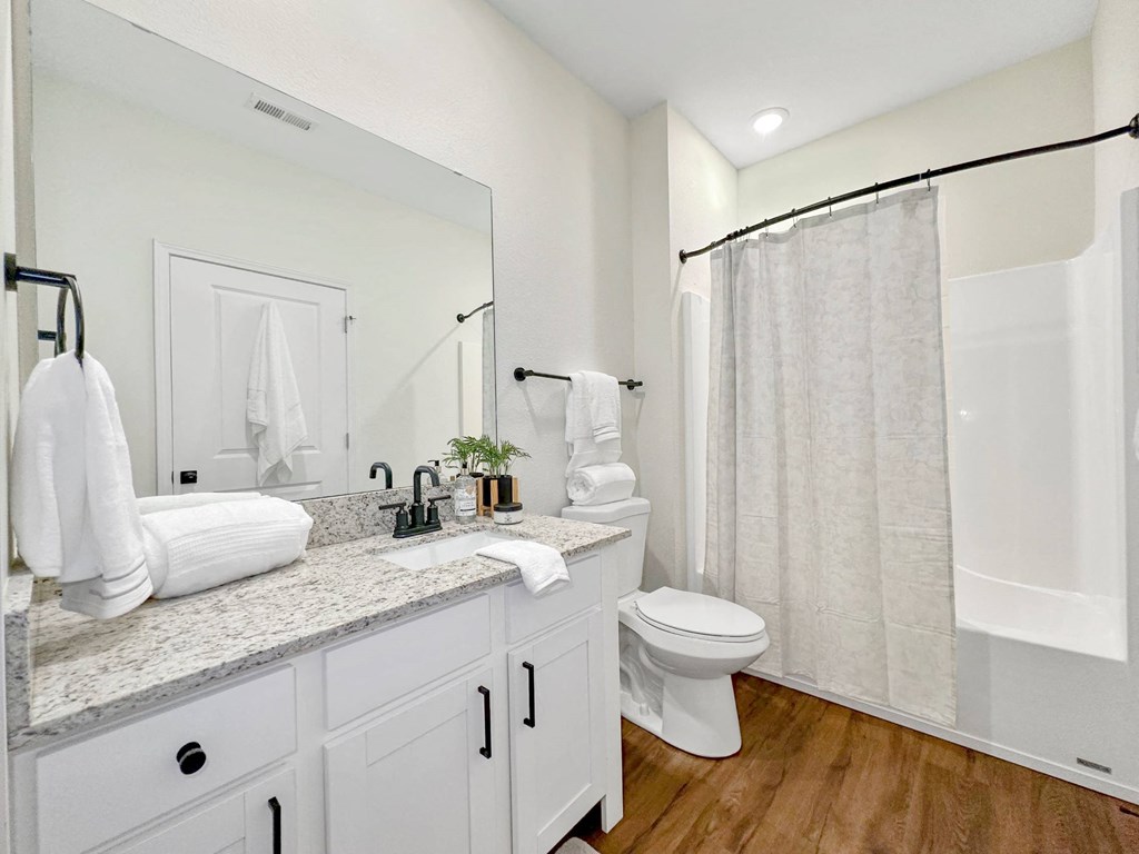 a bathroom with a shower and a toilet and a sink at 92West, West Des Moines