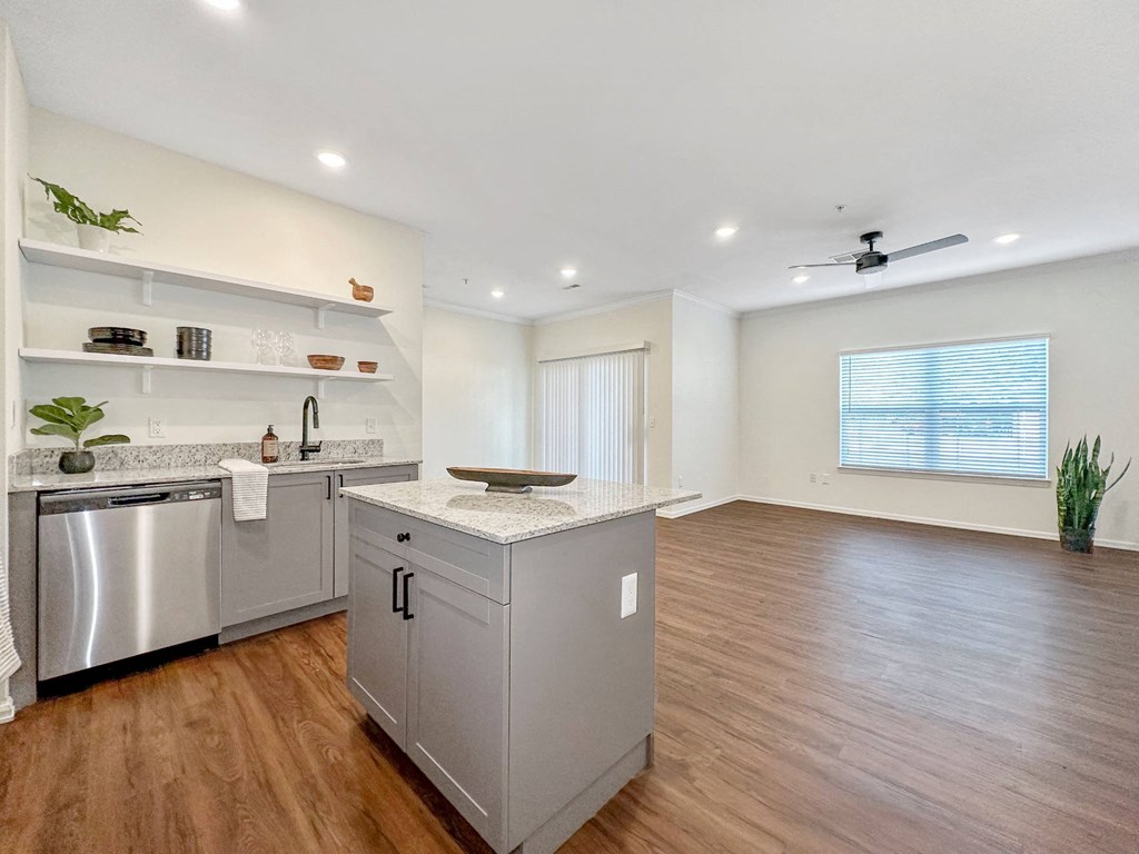 a kitchen with a counter top and a stainless steel refrigerator at 92West, West Des Moines, Iowa