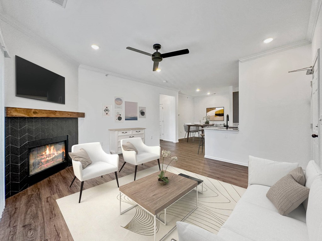 a living room with a couch and a coffee table and a fireplace at 92West, West Des Moines, Iowa