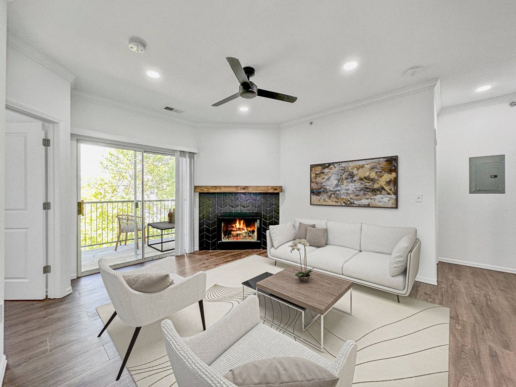 a living room with couches and chairs and a fireplace at 92West, West Des Moines  