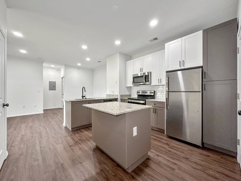 a kitchen with stainless steel appliances and white cabinets at 92West, West Des Moines, IA  