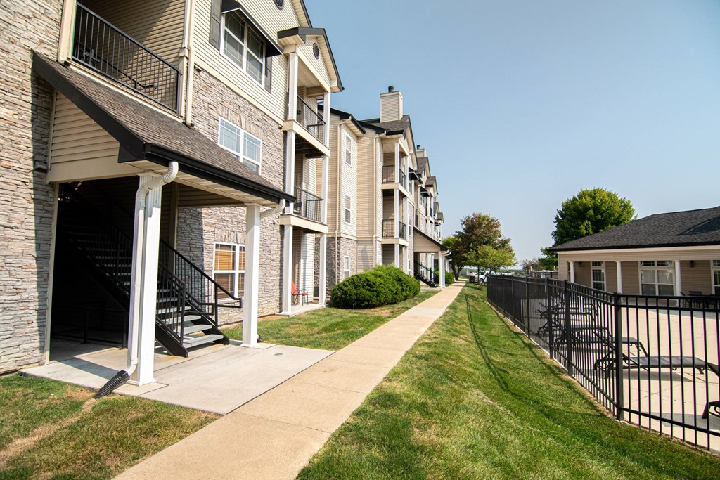 an apartment building with a sidewalk in front of it at 92West, West Des Moines, IA 50266  