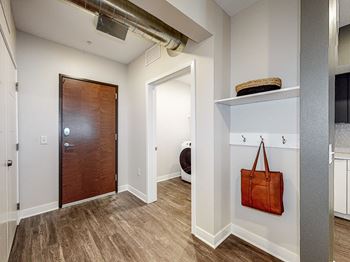 A room with a brown door and a brown bag hanging on the wall.at Linc, Iowa, 50309