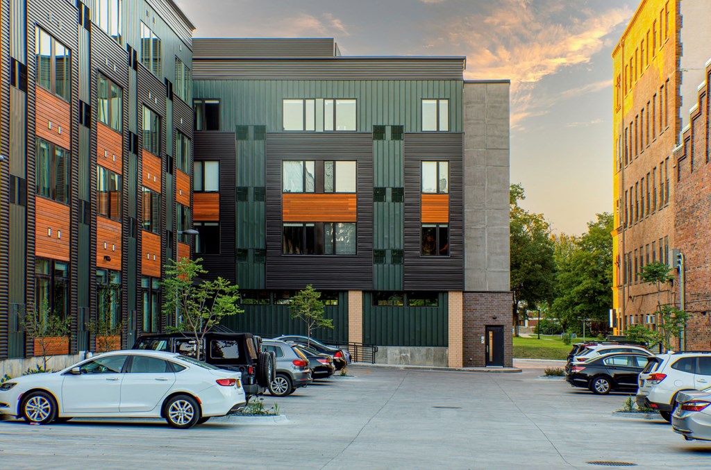 a city street with cars parked in front of a building at Canary Lofts, Des Moines, 50311
