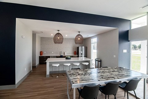 A modern kitchen with a dining table and chairs.