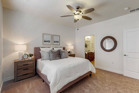 a bedroom with a bed and a ceiling fan at Centennial Crossing, Iowa, 50263