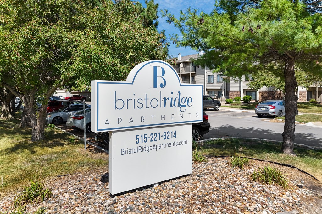 A sign for Bristol Ridge Apartments with a phone number on it.