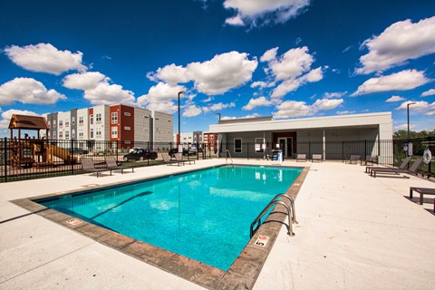 A large swimming pool in a sunny outdoor setting.