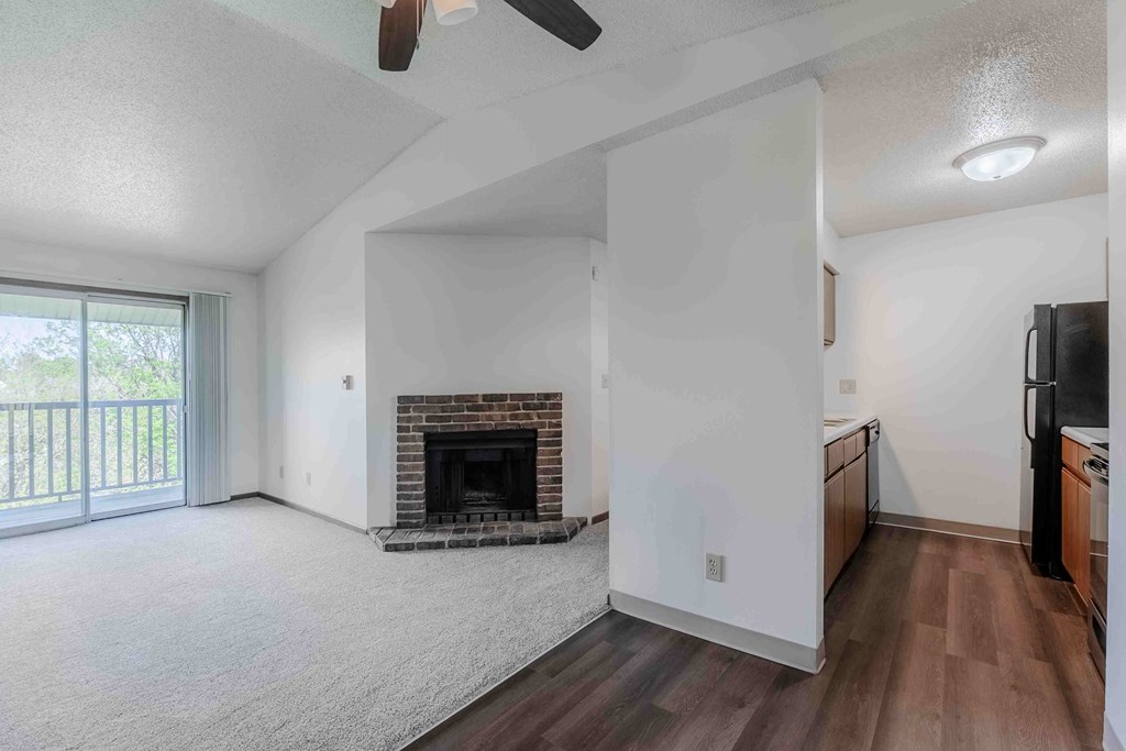 A living room with a fireplace and a television.