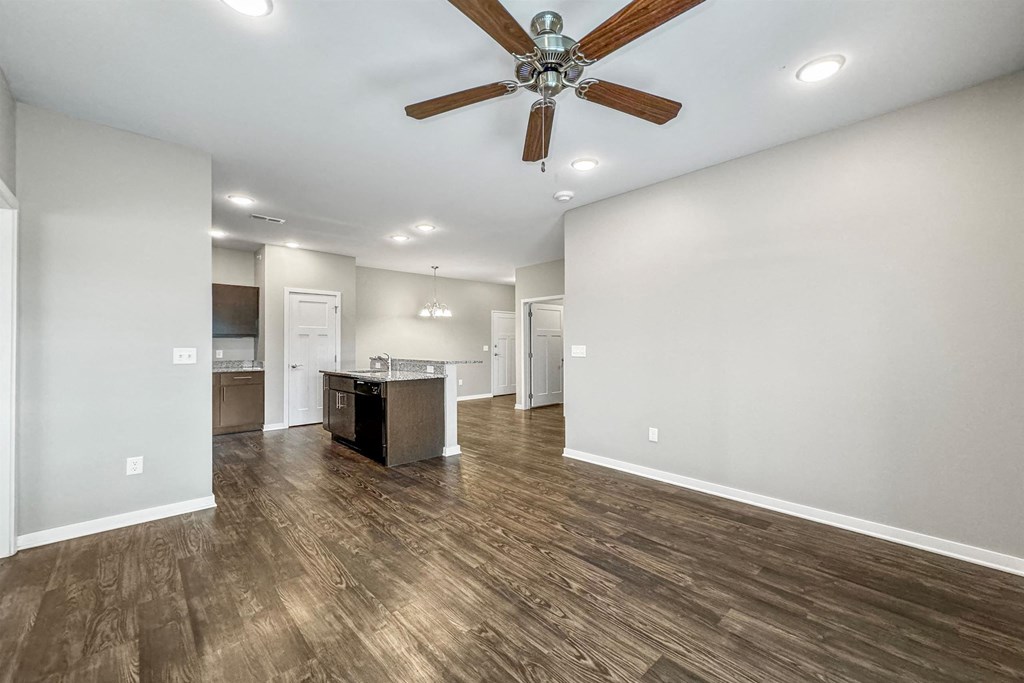 A spacious room with a ceiling fan and wooden flooring at The Barclay Apartments, Altoona, 50009
