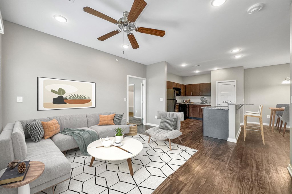 a living room with a couch and a ceiling fan at The Barclay Apartments, Altoona, 50009