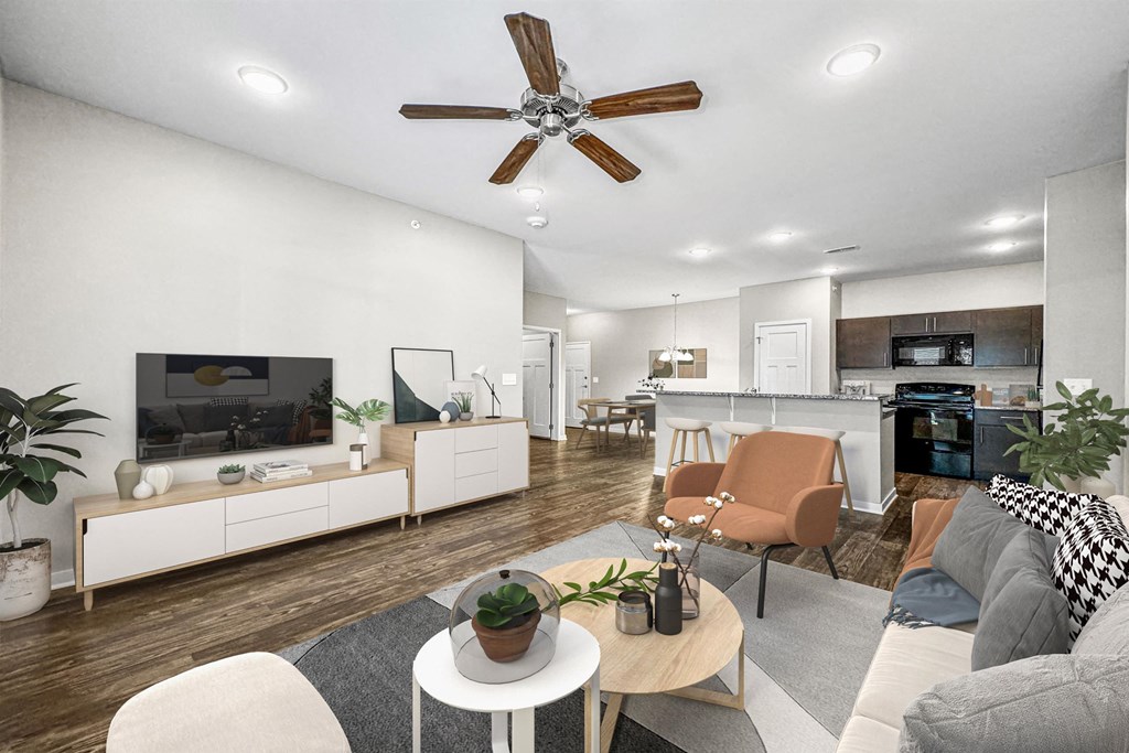 a living room with furniture and a ceiling fan at The Barclay Apartments, Altoona, IOWA
