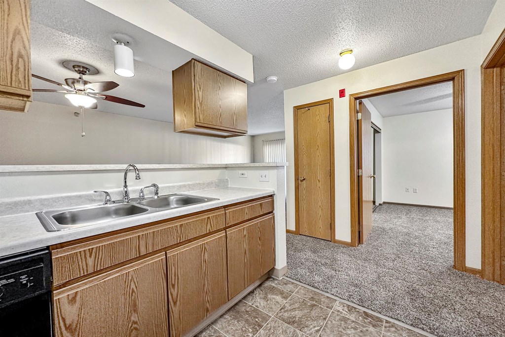 a kitchen with a sink and a ceiling fan at Somerset Apartments, Des Moines, 50315