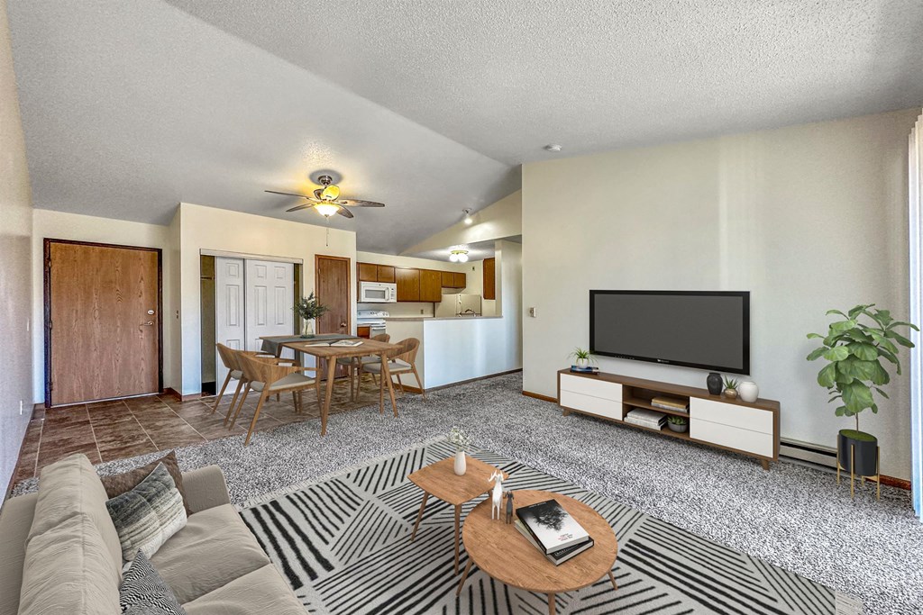 a living room with a couch and a table and a tv at Somerset Apartments, Iowa