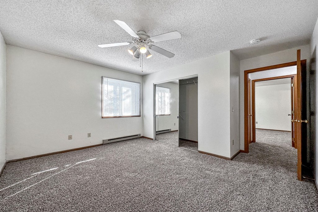 an empty living room with a ceiling fan at Somerset Apartments, Des Moines, IA, 50315