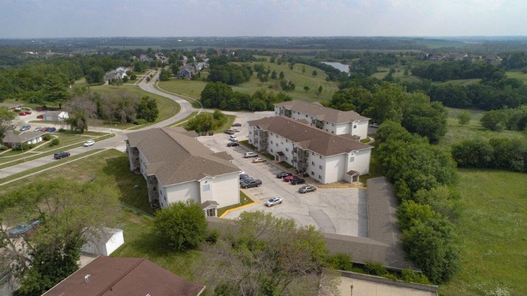 an aerial view of a neighborhood with houses and a road