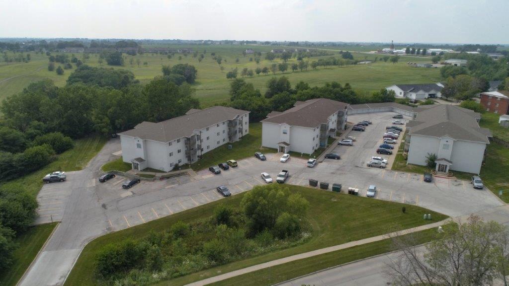 an aerial view of some buildings and a parking lot