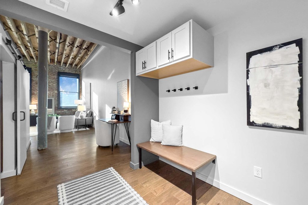A room with a bench and a painting on the wall.at Plant 1 Lofts, Iowa, 50208