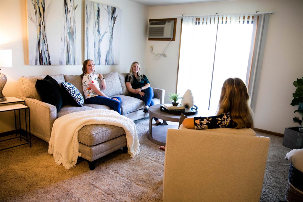 three women sitting in a living room talking  at Bristol Ridge, Urbandale, IA, 50322