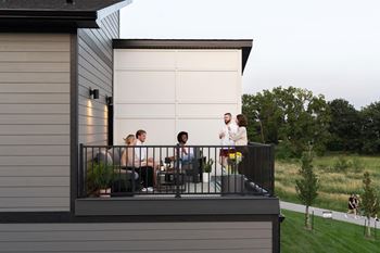a group of people standing on a balcony at Rialto Townhomes Apartments, Waukee