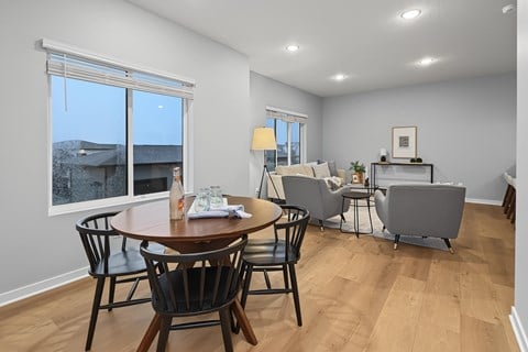 A dining room with a table and chairs.