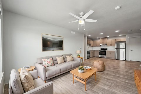 A living room with a grey couch and a coffee table.