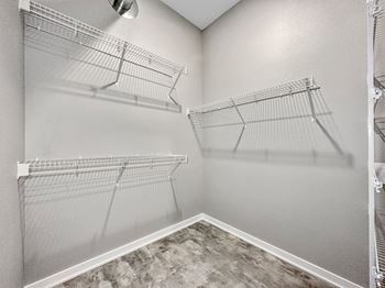 A walk-in closet with shelving and a fan.at Level, Des Moines, IA 50309  