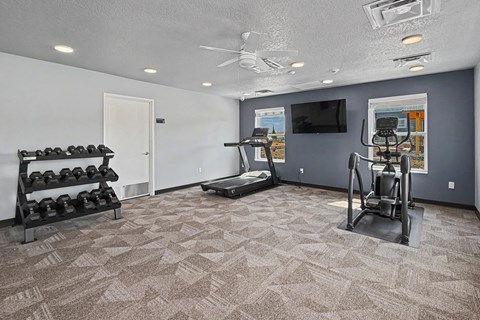 Fitness center with cardio equipment at The Collective on 13th Apartments, Iowa