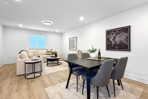 Open concept dining and living area with wood flooring at The Flats at West Glen Apartments, West Des Moines
