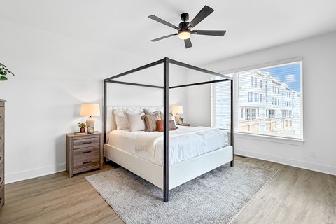 Bedroom with canopy bed and ceiling fan at The Flats at West Glen Apartments, West Des Moines, Iowa