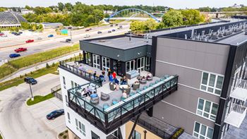 A group of people are sitting on a balcony of a building.at Level, Des Moines, IA 50309  