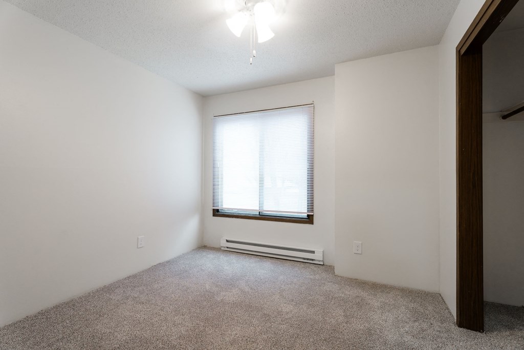 A room with a window and a carpeted floor. at Bristol Ridge, Iowa, 50322