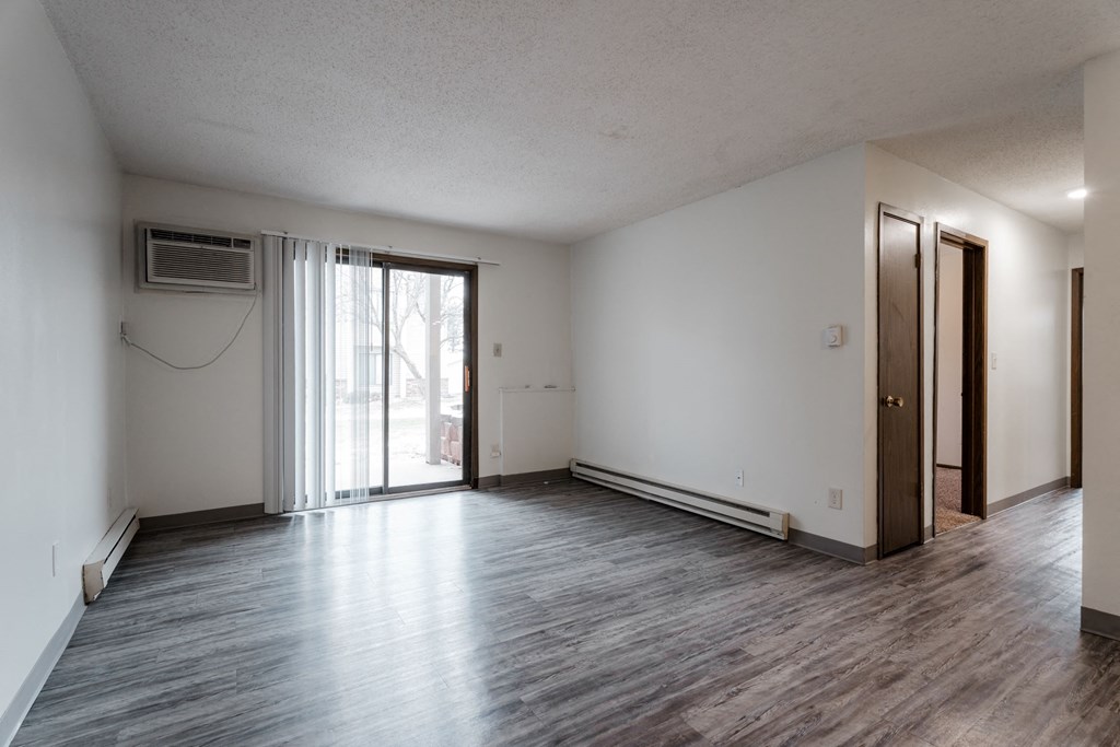 A room with a sliding glass door and a brown door. at Bristol Ridge, Urbandale, IA
