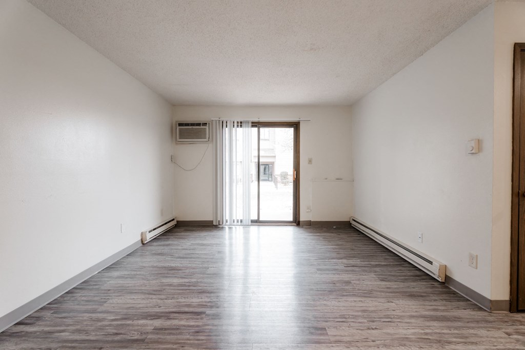 A large empty room with a doorway leading to another room. at Bristol Ridge, Urbandale, Iowa