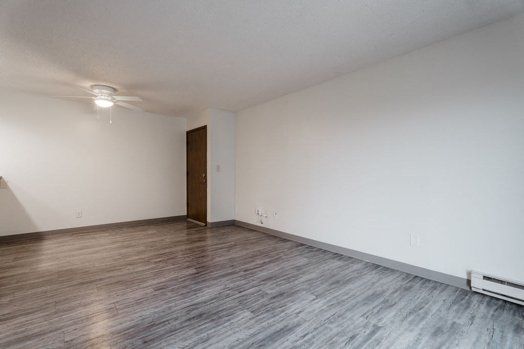 A room with a wooden floor and a brown door. at Bristol Ridge, Iowa, 50322