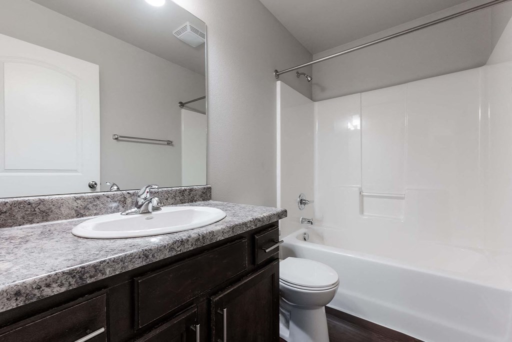 A bathroom with a sink, toilet, and bathtub. at Danamere Village, Carlisle