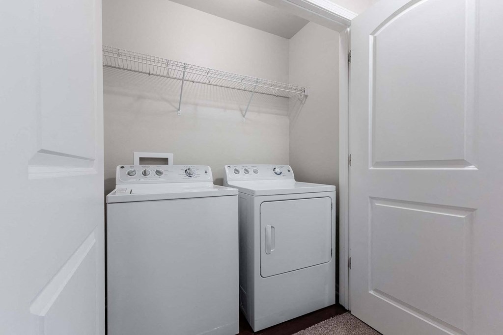 A white laundry room with a washer and dryer. at Danamere Village, Carlisle, Iowa