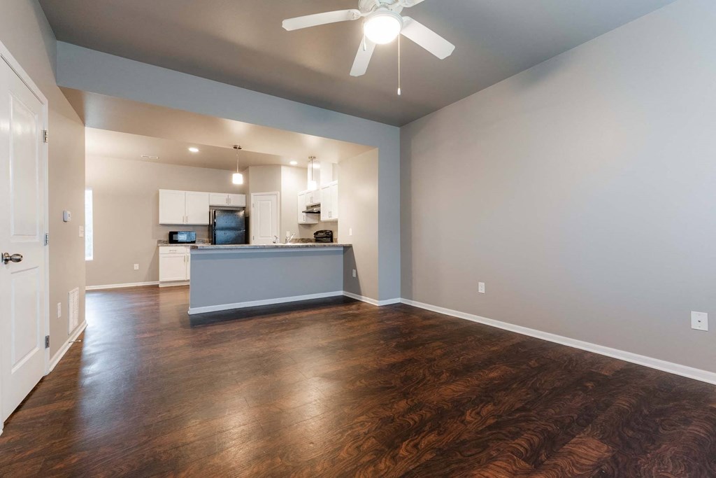 A spacious kitchen with a ceiling fan and wooden floors. at Danamere Village, Iowa, 50047