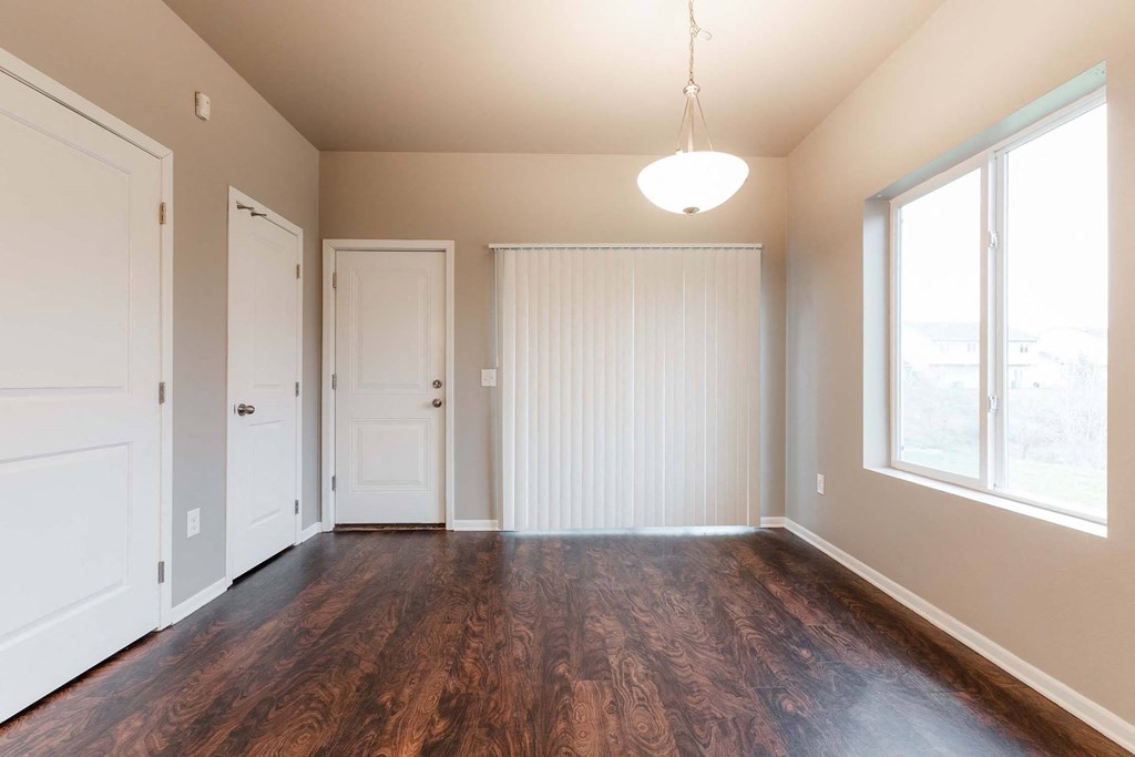 A room with wooden floors and white walls. at Danamere Village, Iowa, 50047