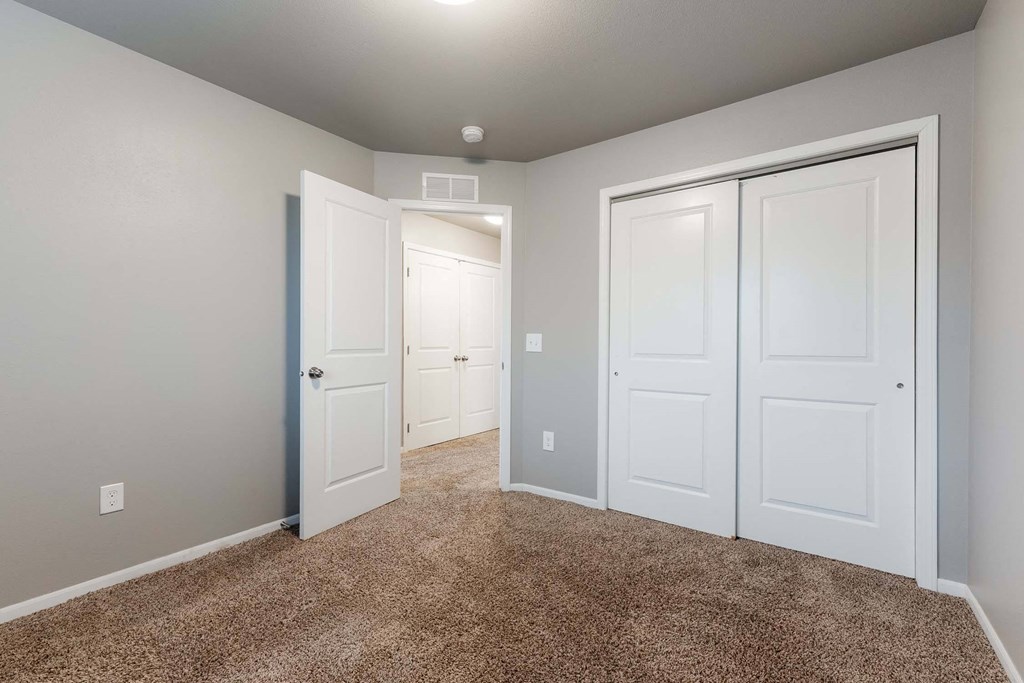 A room with white doors and carpeted floor. at Danamere Village, Iowa, 50047