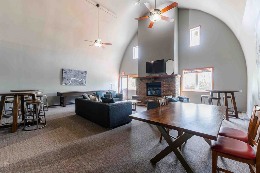 A living room with a fireplace and a television.