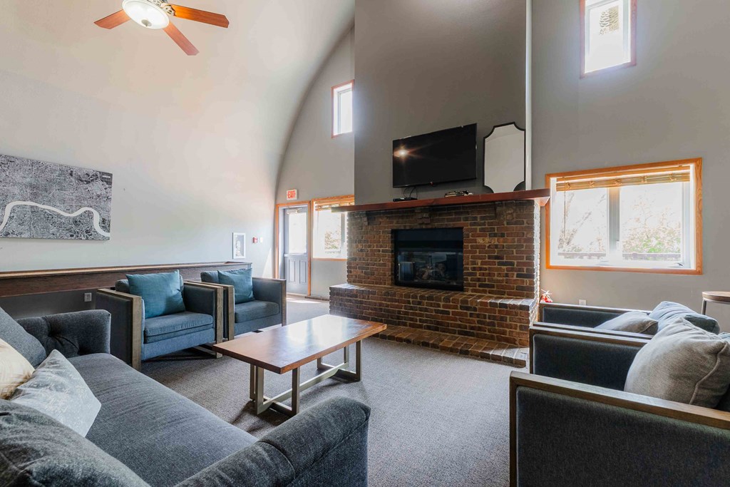 A living room with a fireplace and a television.
