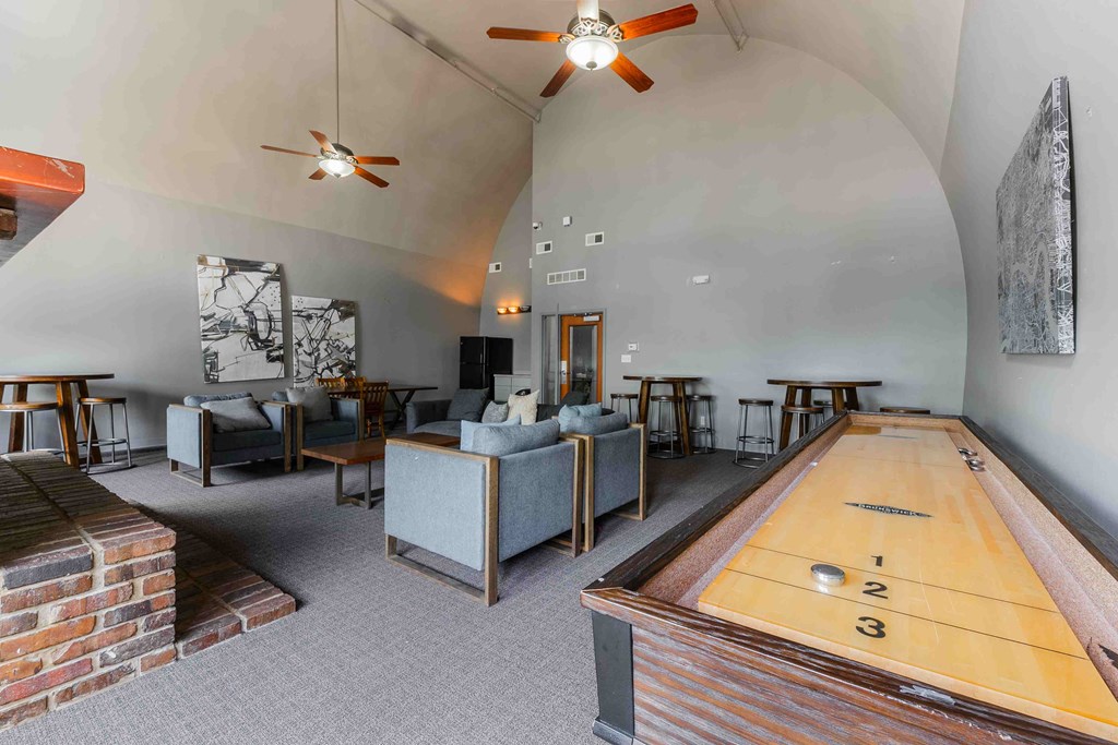 A room with a pool table and a shag carpet.