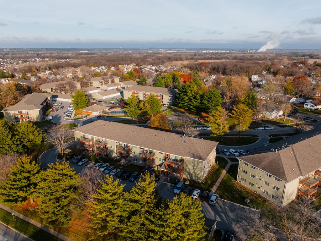 A large building surrounded by trees in the fall. at Rosemont Place Apartments, Des Moines, IA